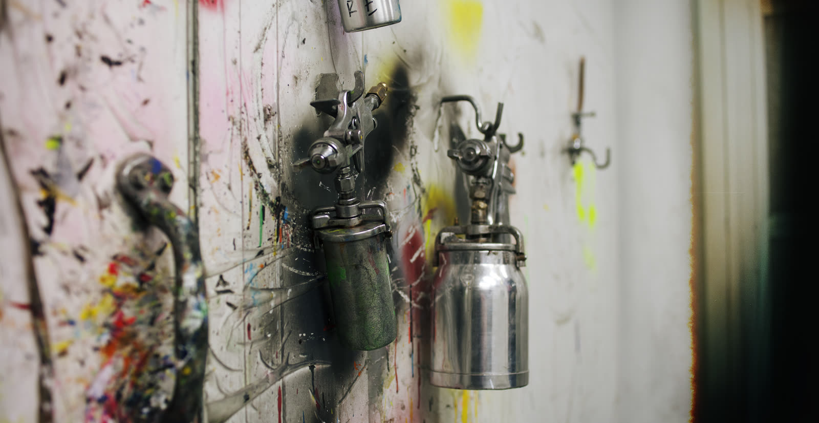 Paint spray guns hanging in the Active Force paint booth